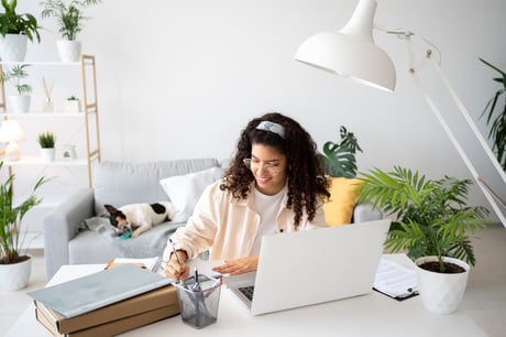 medium-shot-woman-working-desk-with-laptop
