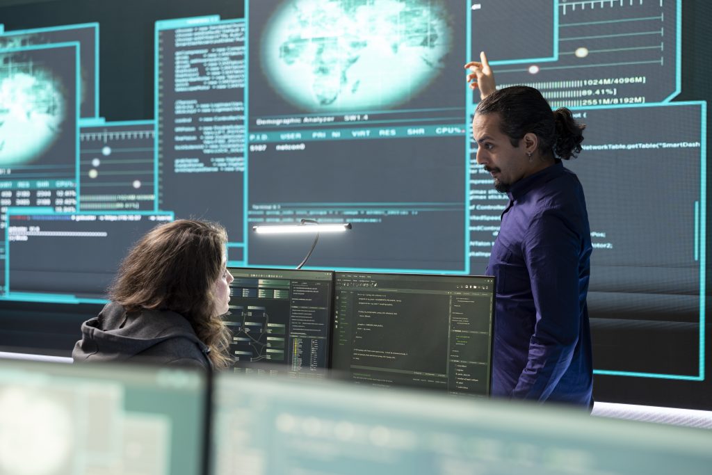 Cybersecurity specialists monitoring compliance and digital security systems in a UK business operations centre