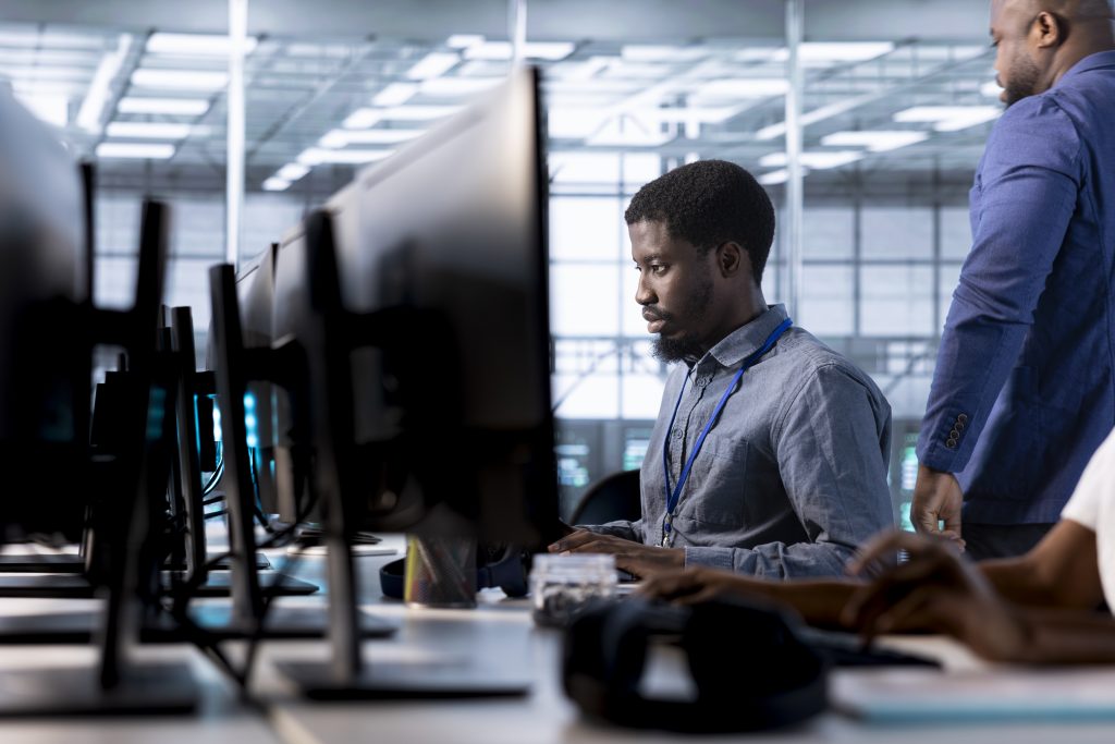 IT professionals monitoring cybersecurity operations and operational resilience systems in a modern enterprise data centre environment