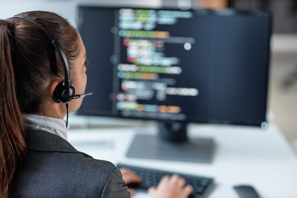 IT support specialist monitoring cybersecurity systems and technical operations on a computer workstation